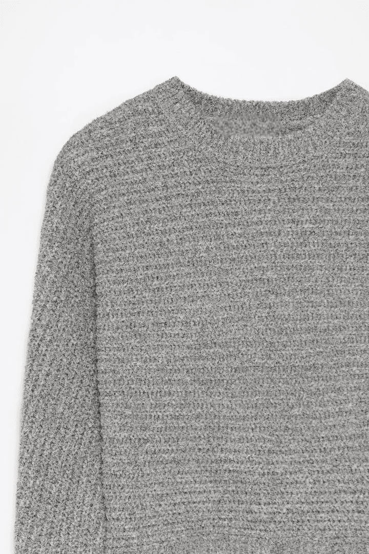 Close-up product image of grey chenille sweater texture

