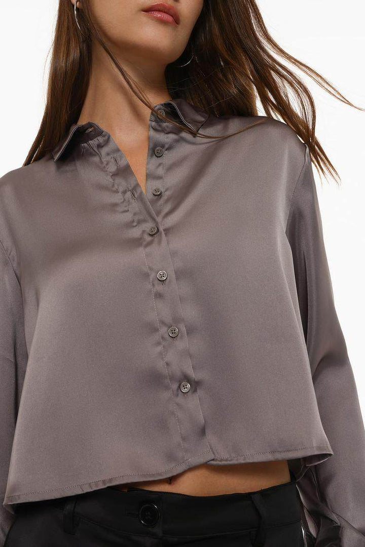 Close-up front view of grey cropped satin shirt

