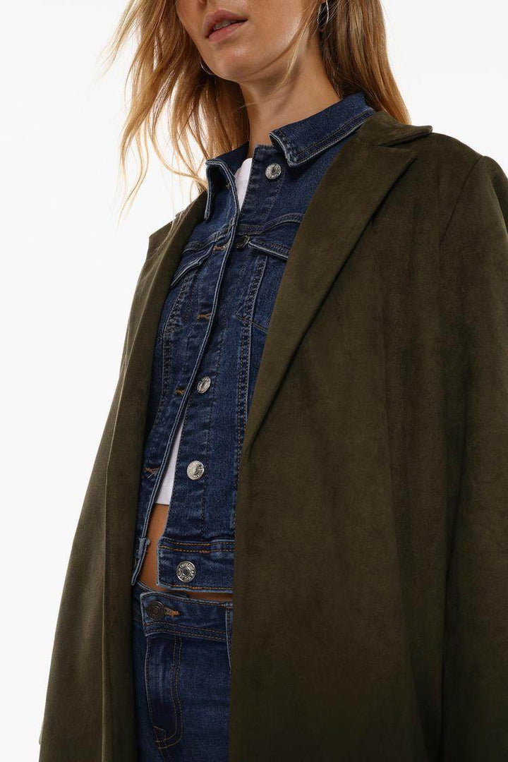 Close-up front view of grey faux suede coat

