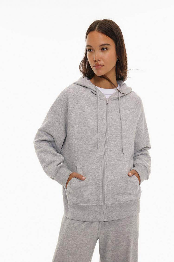 Model showcasing grey hooded jacket front view

