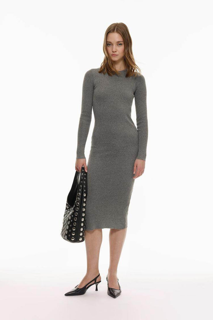 Full body front view of a woman wearing a grey knit midi dress

