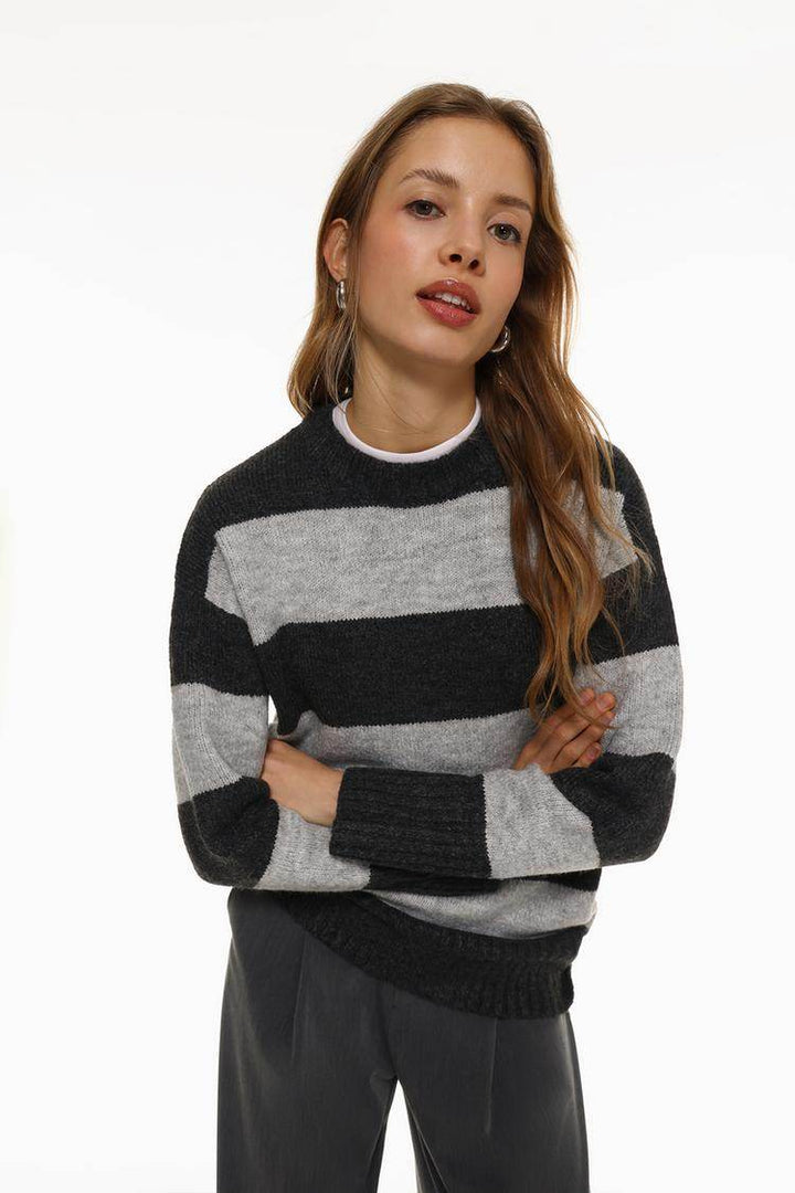 Full body front view of woman wearing grey long soft sweater

