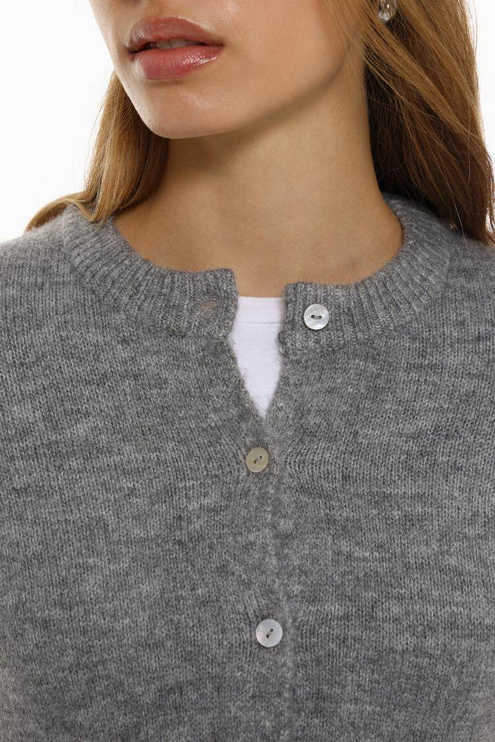 Close-up front view of grey knit cardigan

