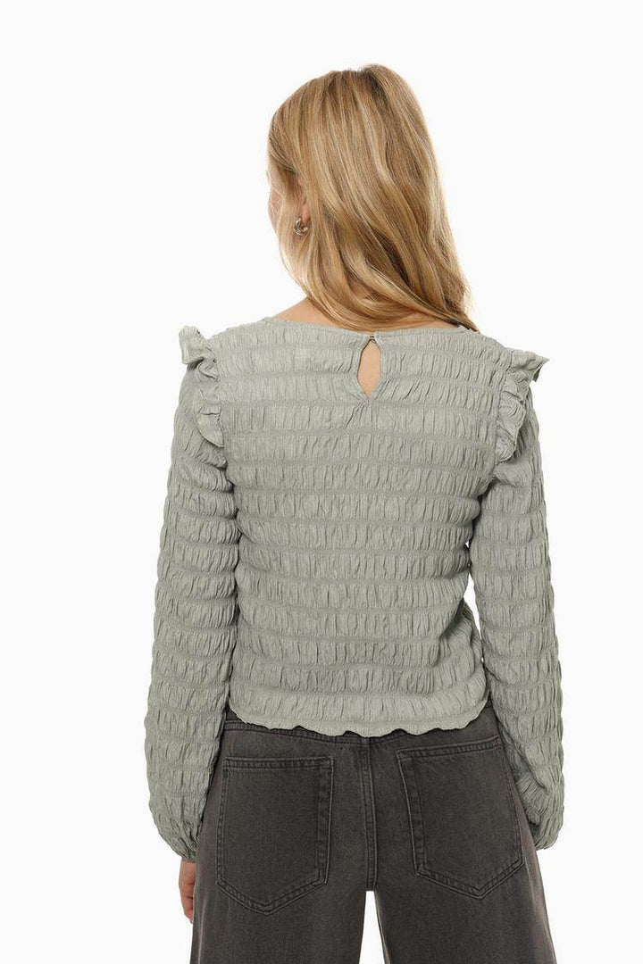 Back view of the women's grey ruffle blouse

