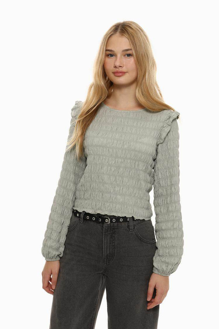 Front view of women's grey ruffle blouse

