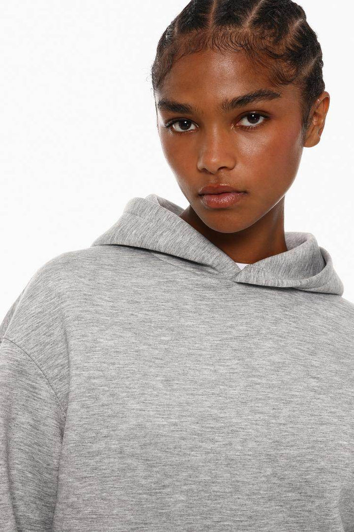 Model showcasing grey tracksuit hoodie front

