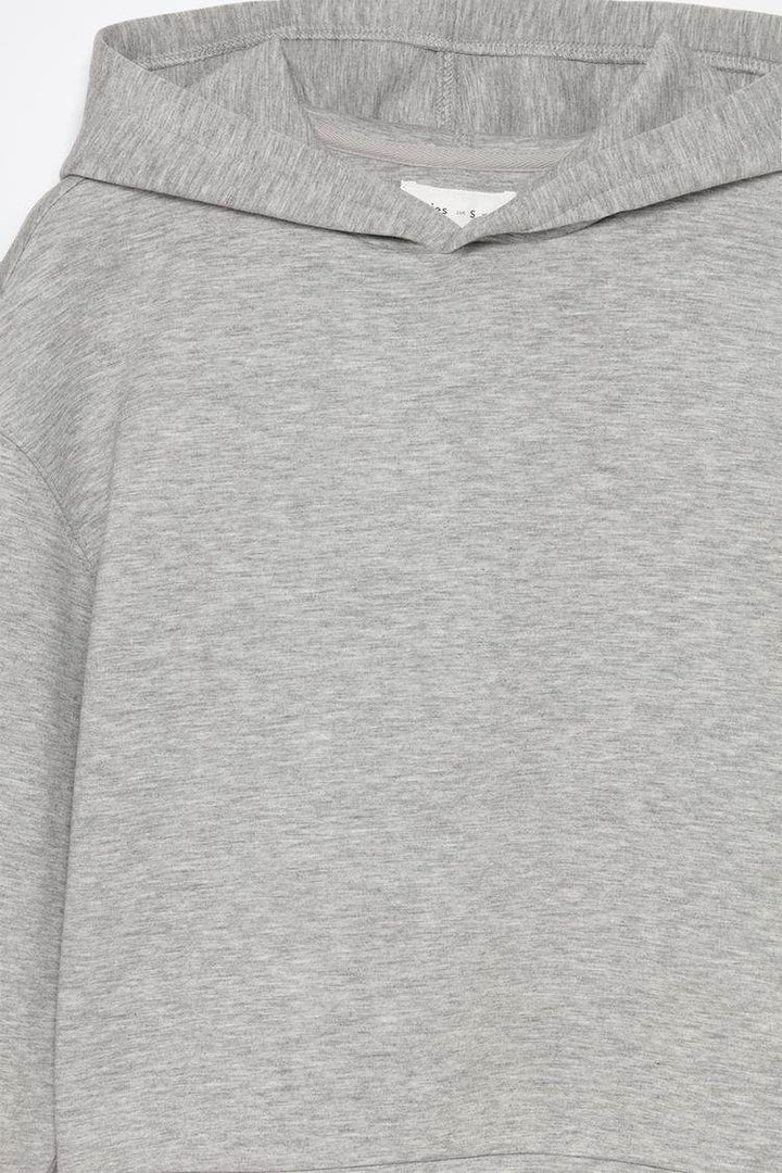 Close-up product image of grey tracksuit hoodie fabric

