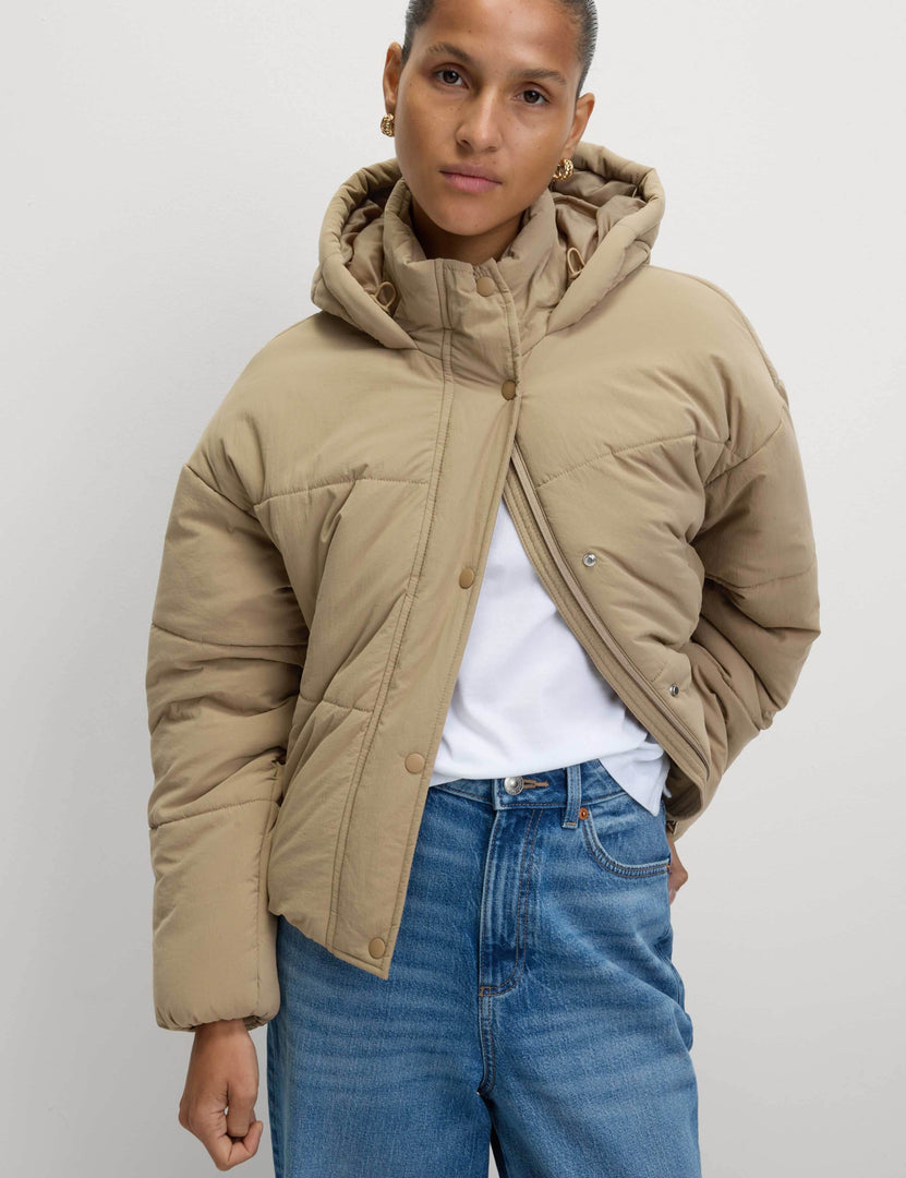 Front view of a women's khaki hooded puffer jacket

