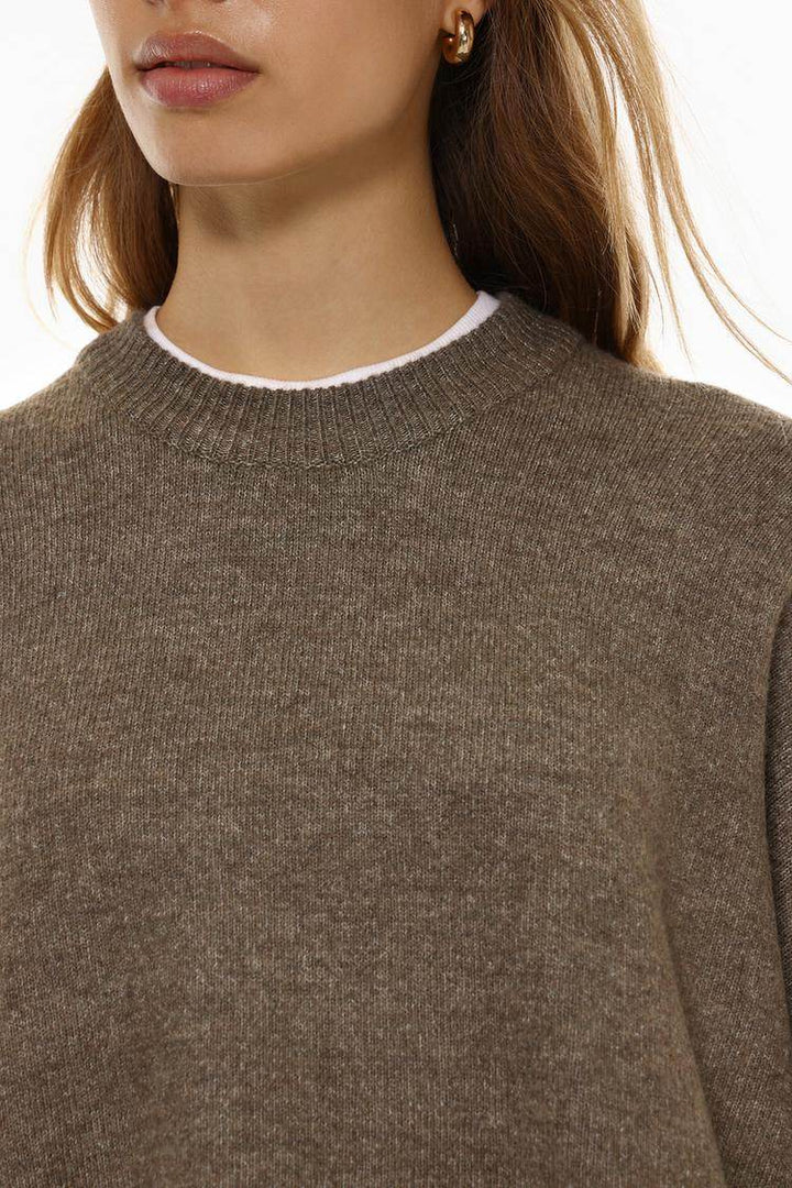Close-up front view of khaki soft knit jumper


