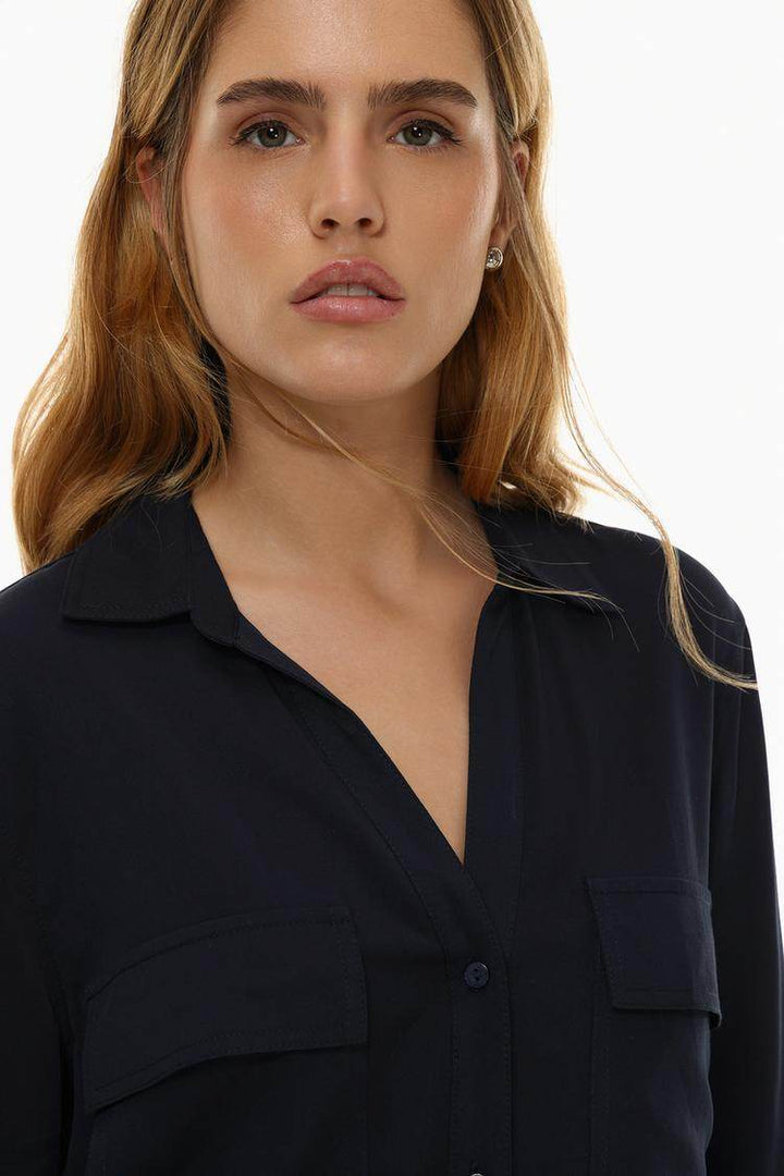 Close-up front view of navy shirt with pockets

