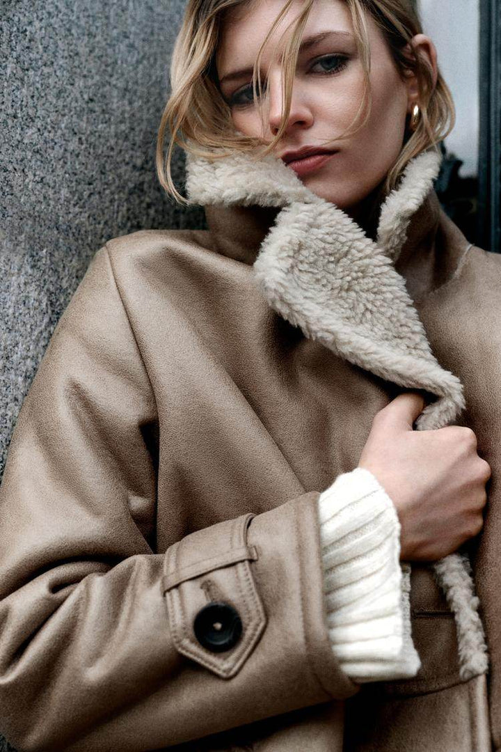 Model showcasing oversize double-breasted coat

