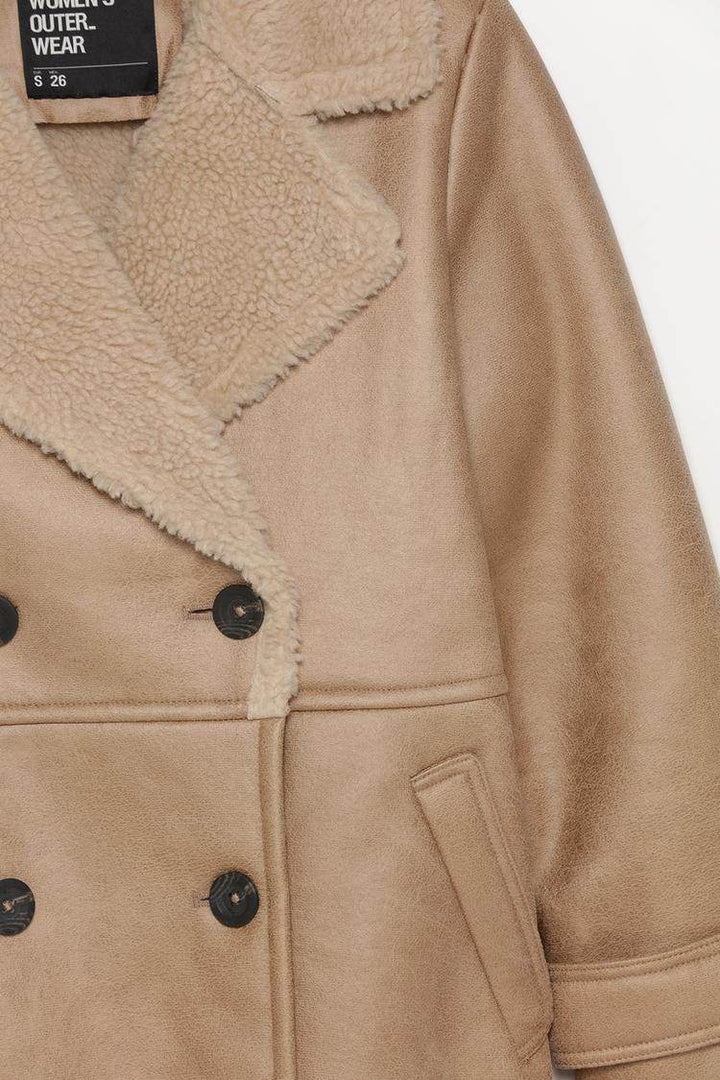Close-up product image of double-breasted coat details

