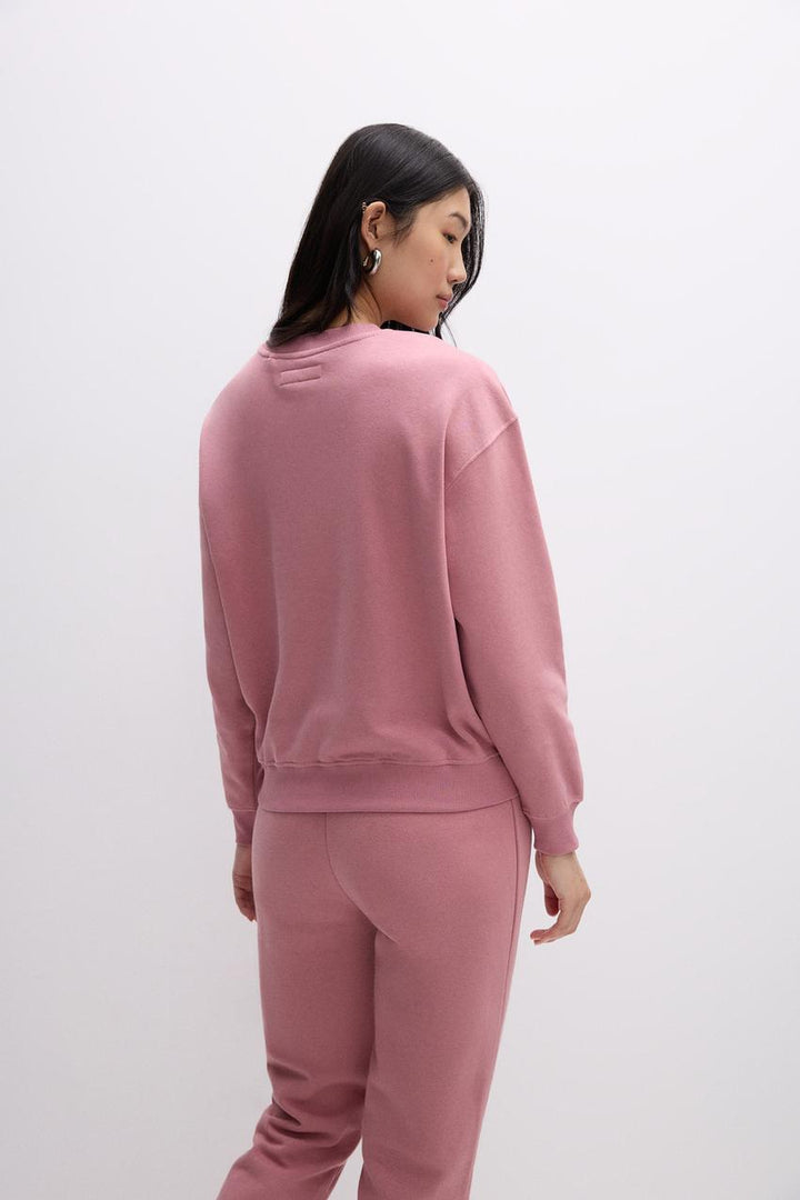 Back view of a pink women's sweatshirt
