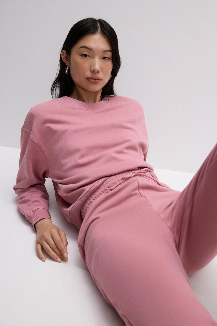 Front view of a pink women's sweatshirt