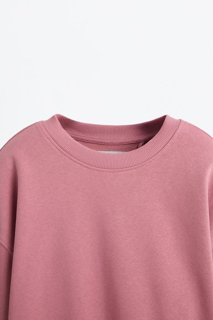 Zoomed view of a pink women's sweatshirt
