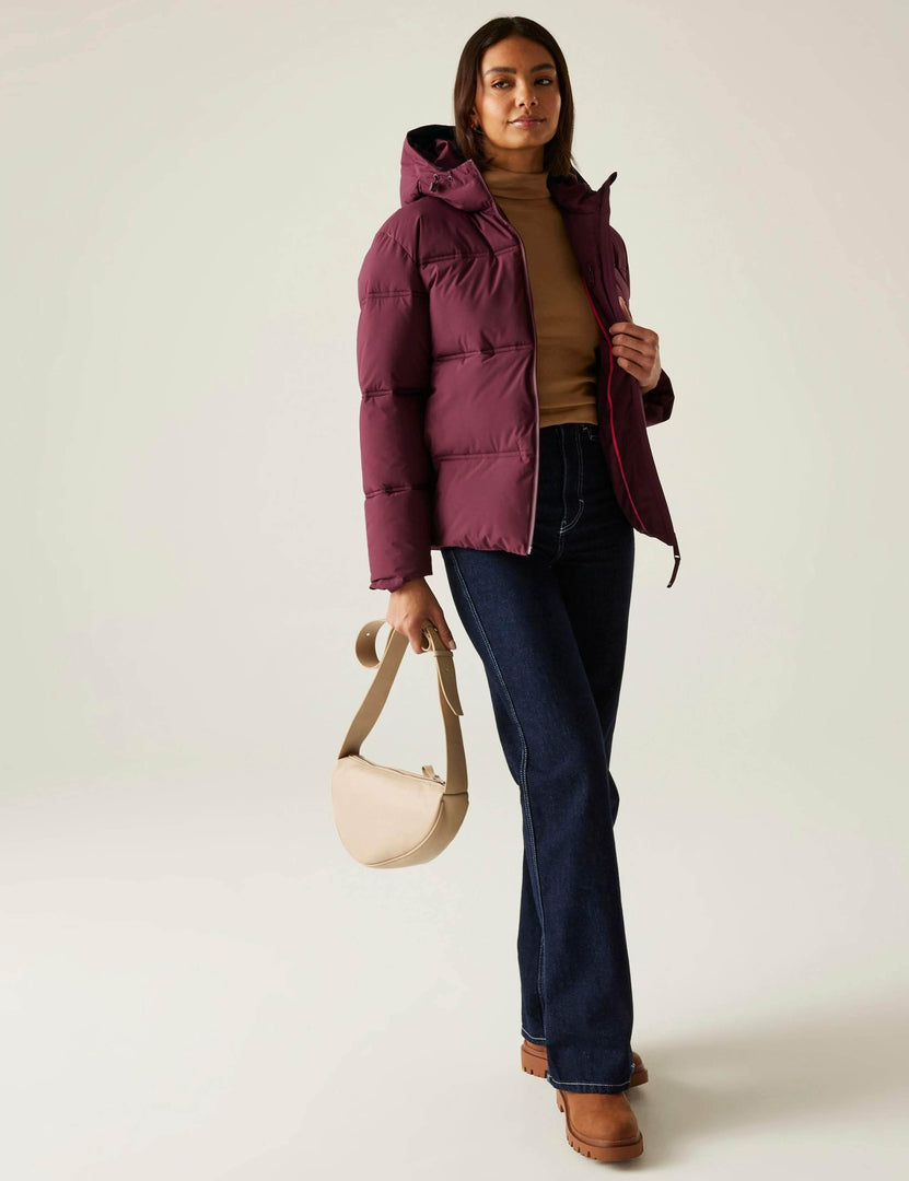 Full body front view of a woman wearing a purple quilted puffer jacket

