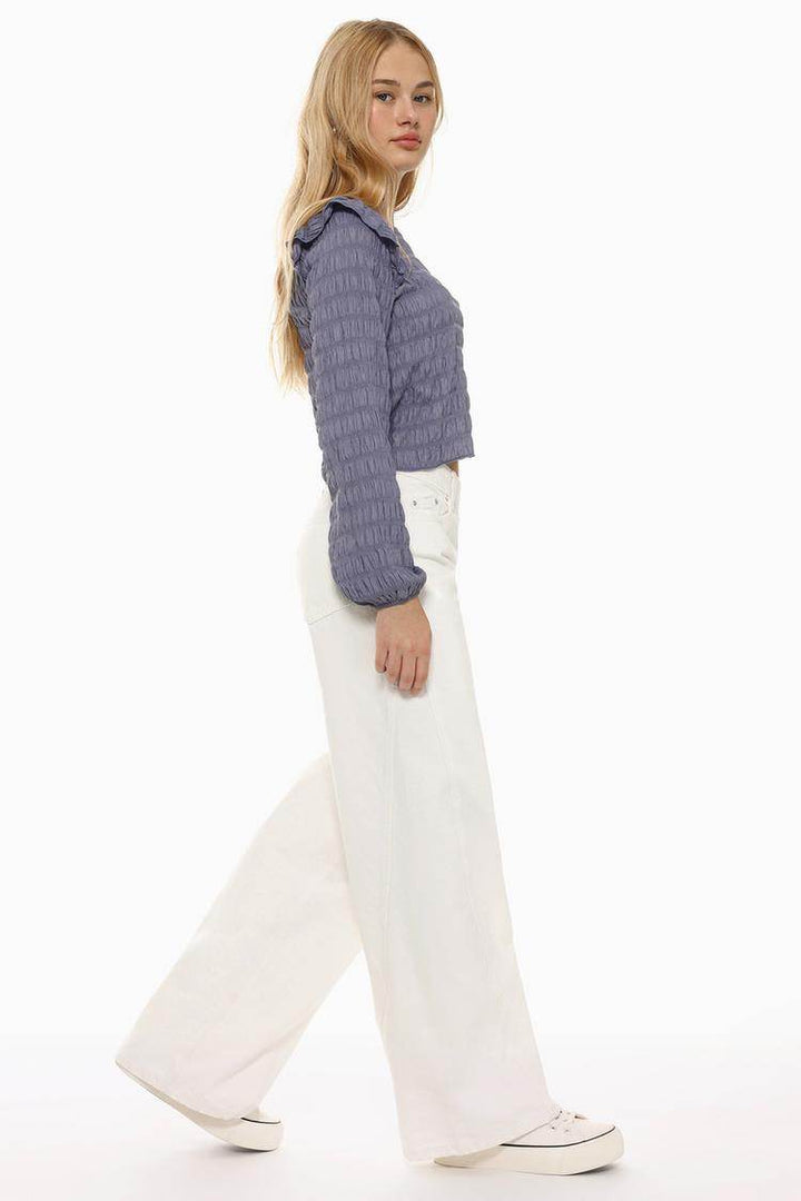 Side view of the women's purple ruffle blouse

