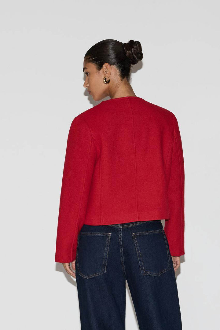 Back view of a red women's cloth jacket
