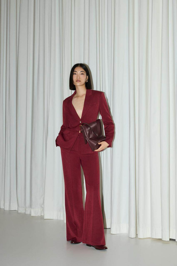 Front full body view of a red women's fitted blazer
