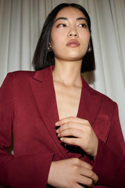 Zoomed front view of a red women's fitted blazer
