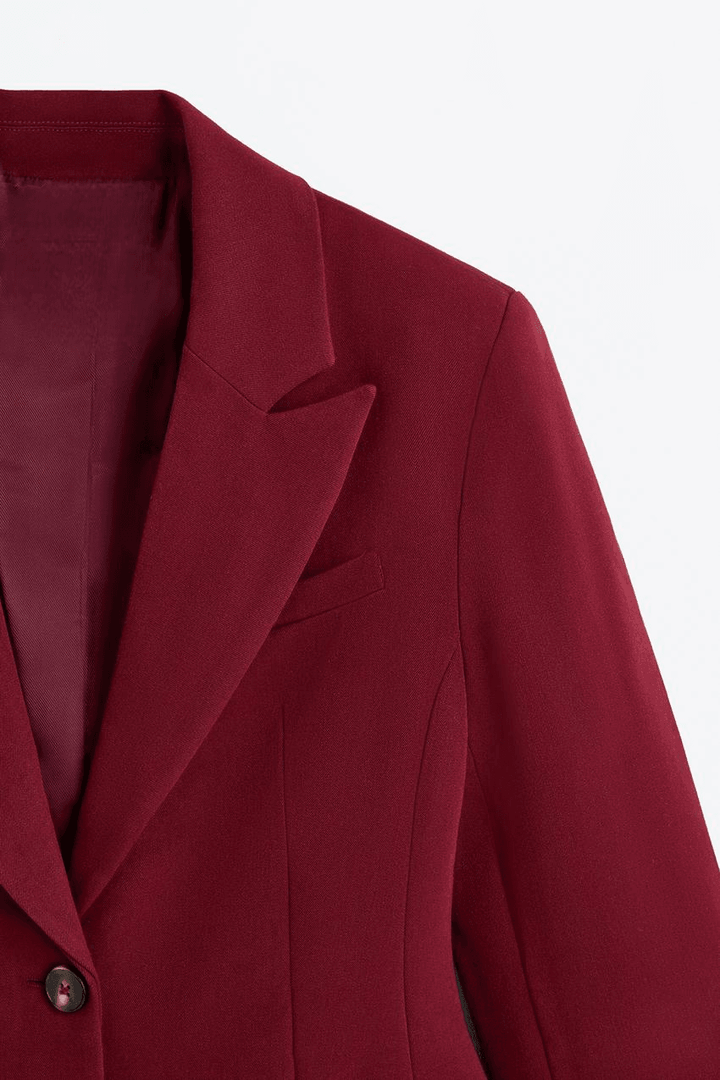 Zoomed view of a red women's fitted blazer
