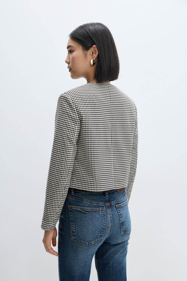 Back side view of a white women's cropped blazer
