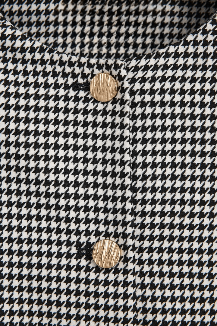Material detail of a white women's cropped blazer
