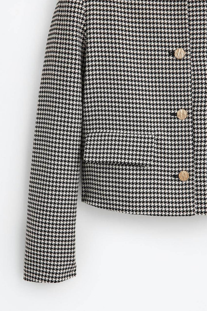 Zoomed view of a white women's cropped blazer
