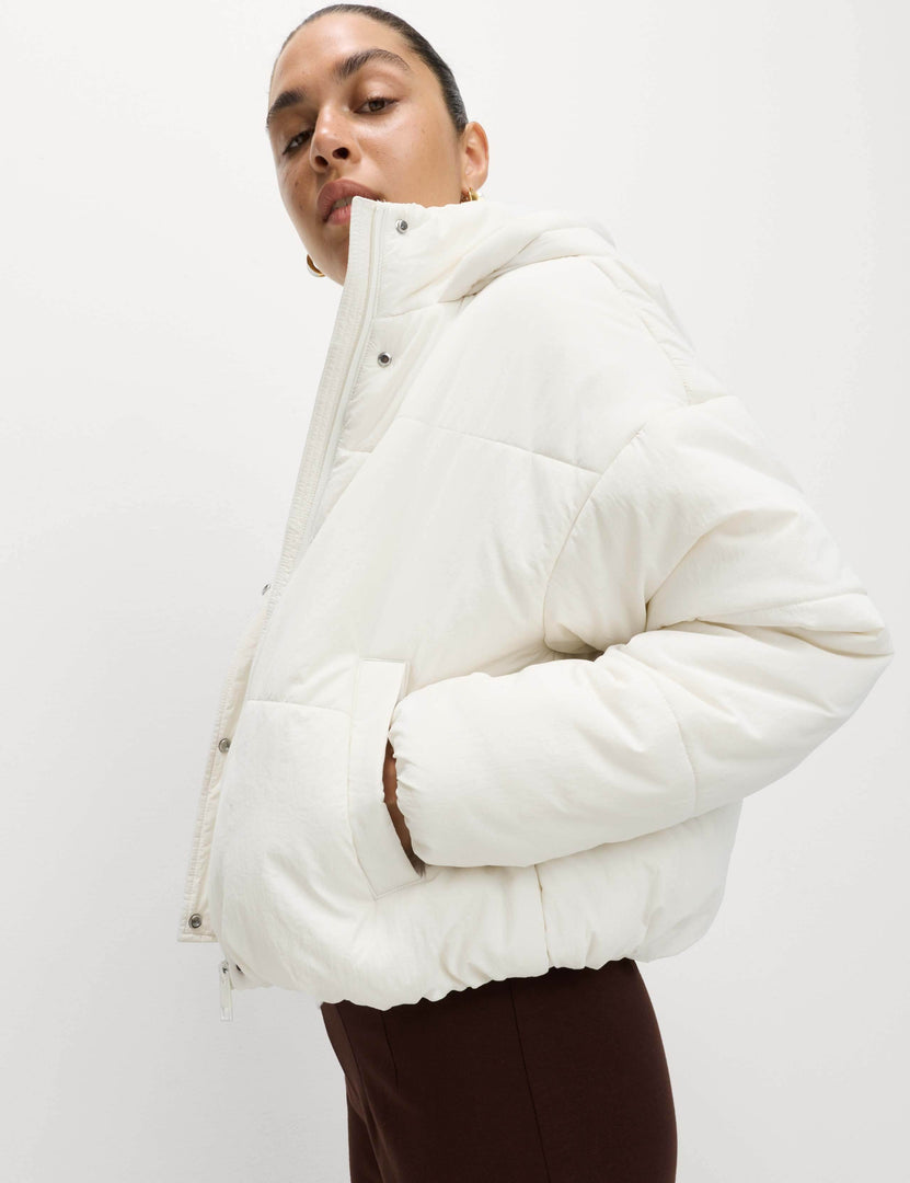 Side view of the women's white hooded puffer jacket


