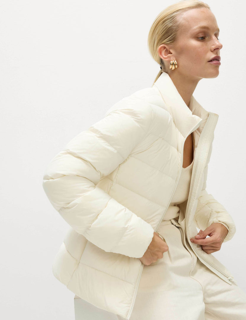 Close-up front view of the women's white puffer jacket


