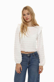 Front view of women's white long sleeve ruffle blouse

