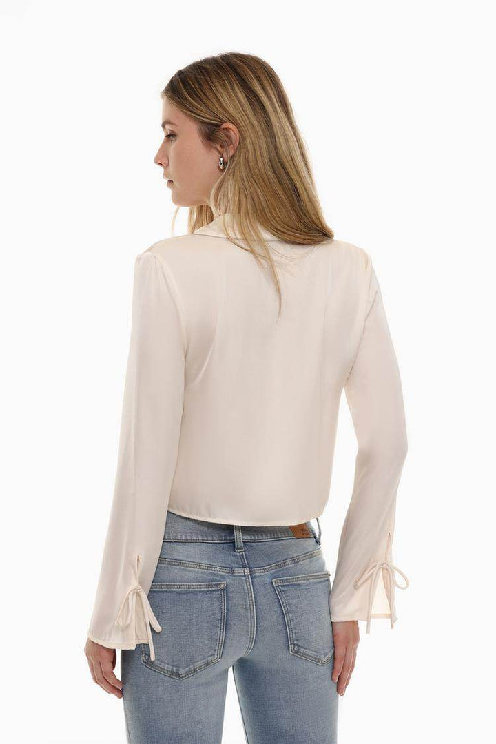 Back view of the women's white satin shirt with ties


