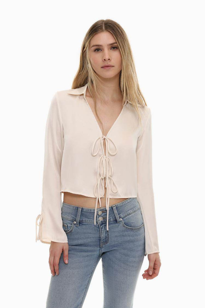 Front view of women's white satin shirt with ties

