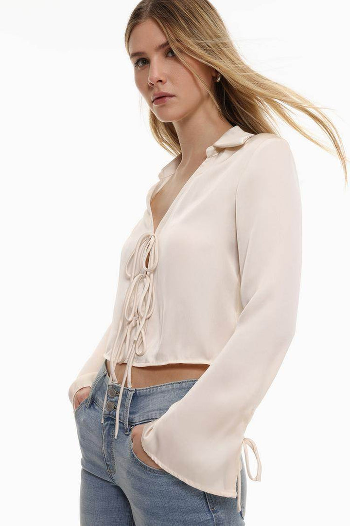 Side view of the women's white satin shirt with ties

