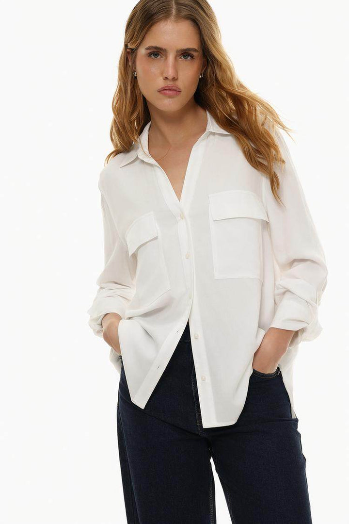 Front view of women's white shirt with pockets

