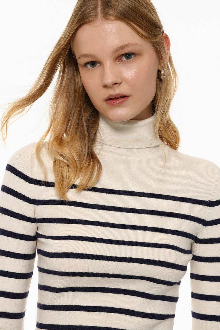 Close-up front view of white turtleneck sweater

