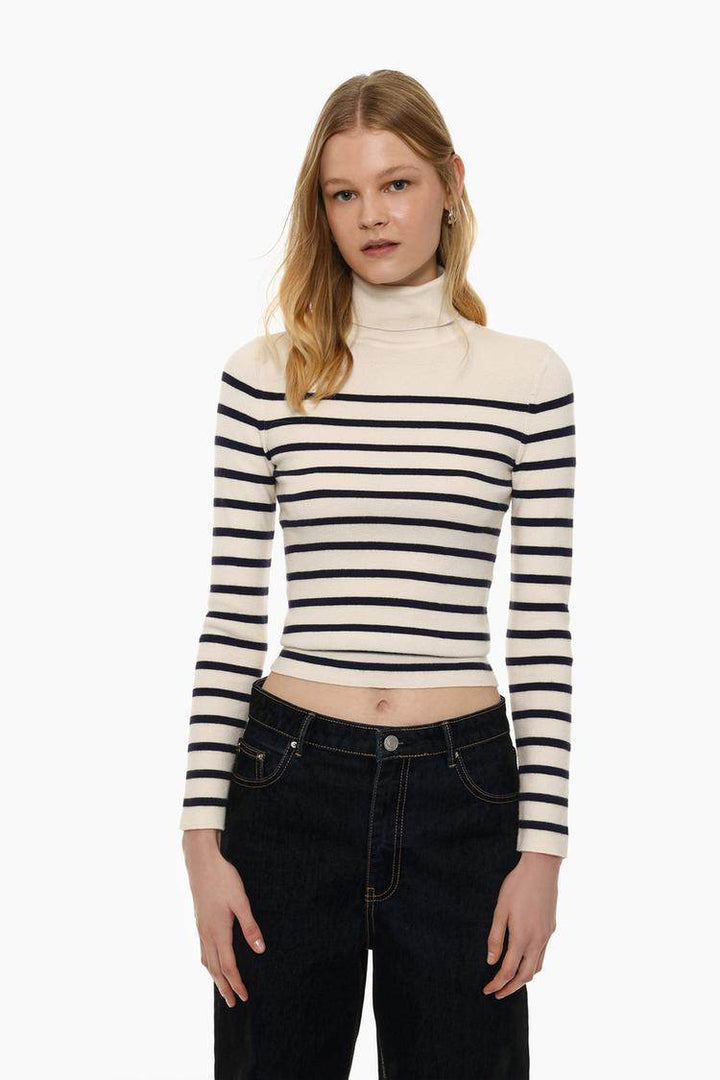 Front view of women's white turtleneck sweater

